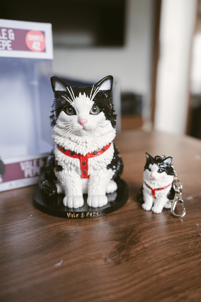 Figuras 3D de dos gatos, blanco y negro, en resina pintada